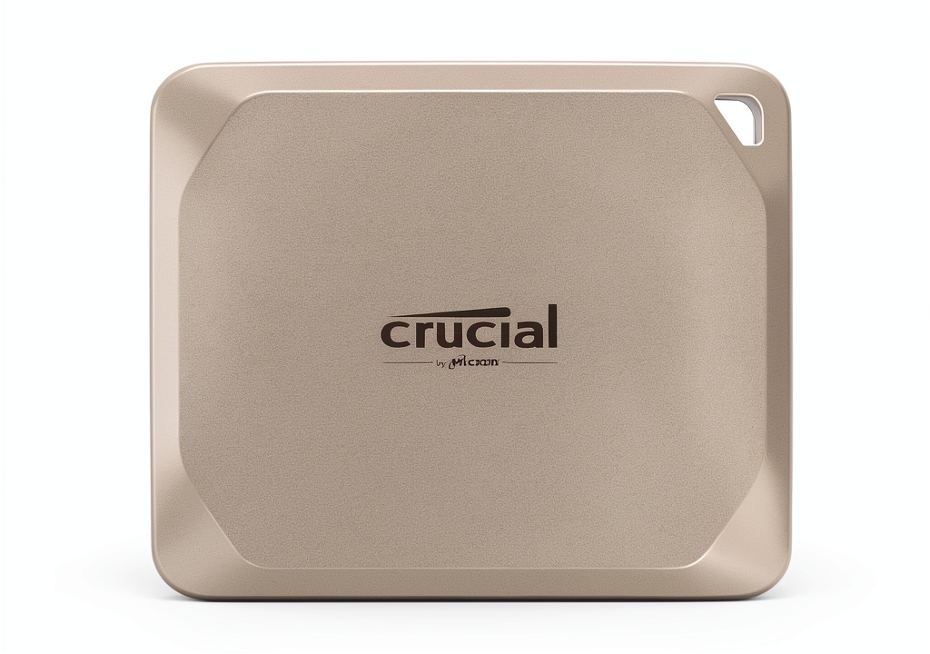 Crucial X9 Pro Mac SSD on a wooden desk with a MacBook Air nearby